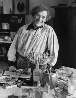 Photo of a smiling Marc Chagall in his studio in Paris, 1933.