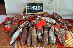 Display of boar sausage with a sign, Sanglier.