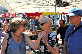 Susan Vreeland  engages a woman from Rooussillon in conversation at the market: Photo Copyright Marcia M. Mueller