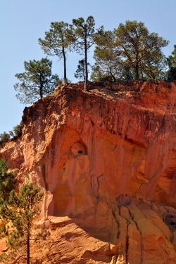 Ochre cliffs scoured by mistral winds and quarrymen into fantastical formations